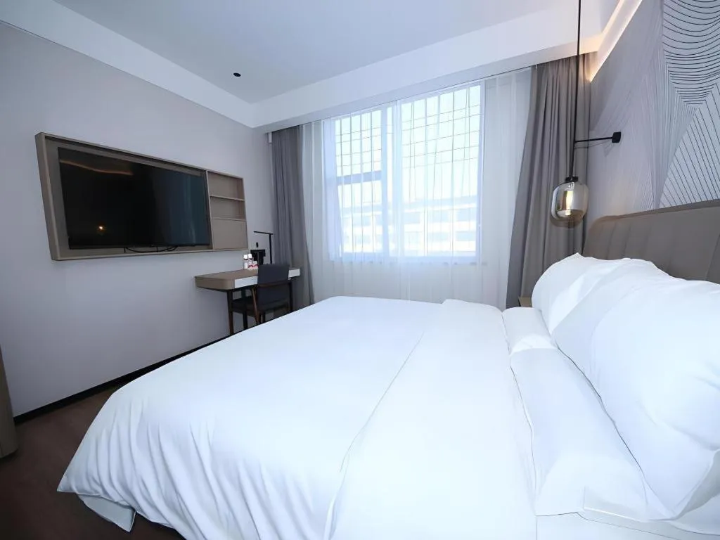 Bed in JUNYI Hotel Jiangxi Xinyu Baoshi Park