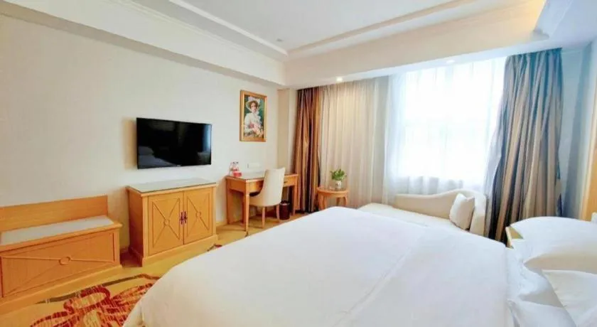 Bed in Vienna Hotel Shenzhen Longgang Baifucheng