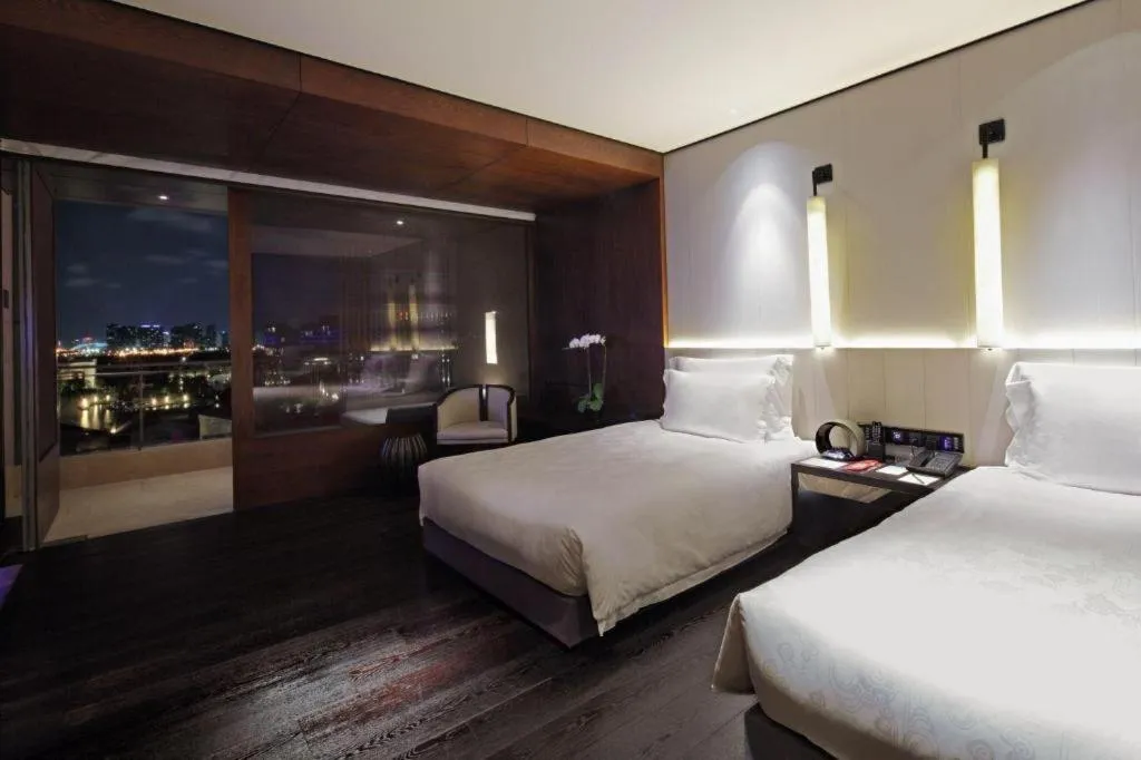 Bed in OCT Bay Breeze Hotel