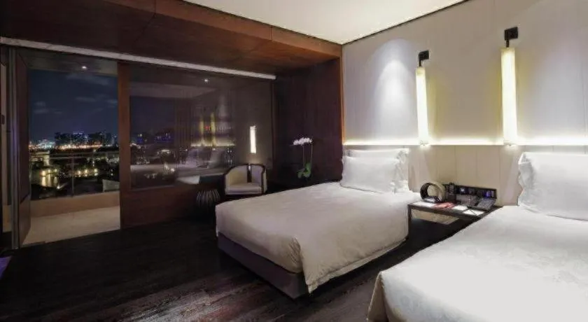 Bed in OCT Bay Breeze Hotel