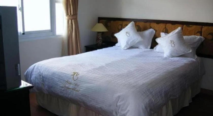 Bed in Golden Ant Hotels