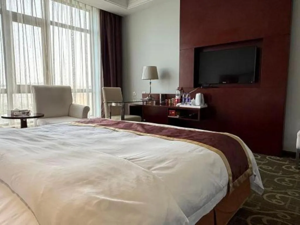 Bed in Xinxiang Zhongzhou Yihe Hotel