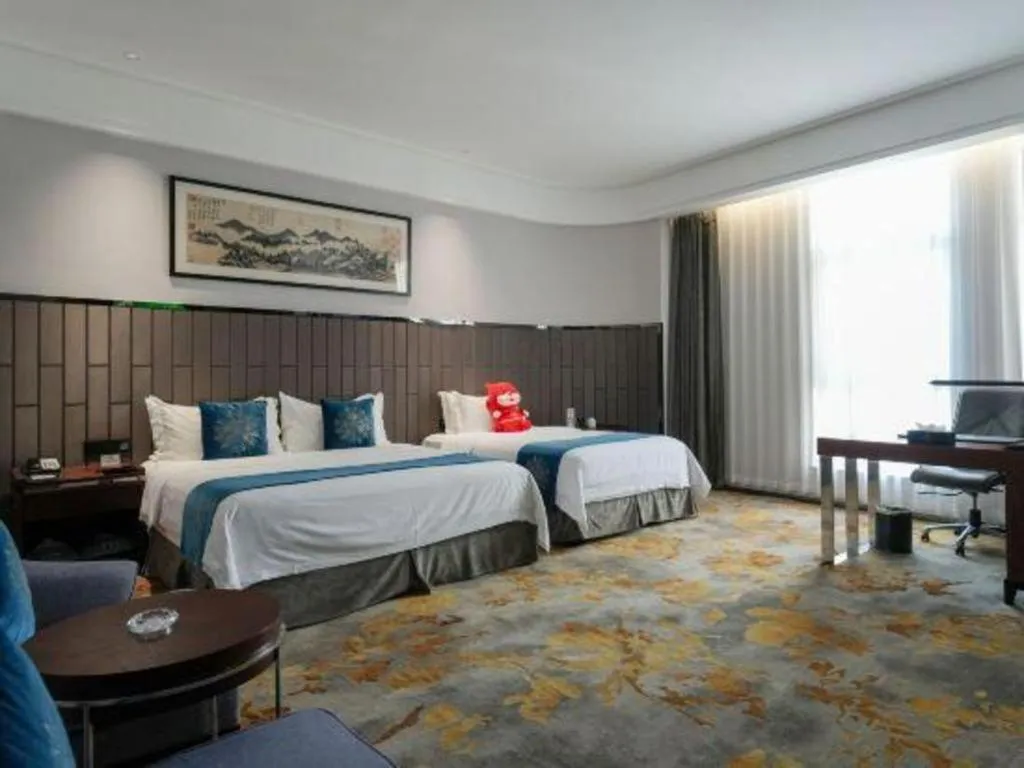 Bed in Jiyuan Oriental Jianguo Hotel