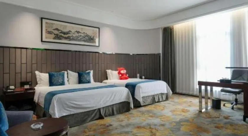 Bed in Jiyuan Oriental Jianguo Hotel