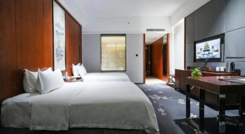 Bed in Jiyuan Oriental Jianguo Hotel