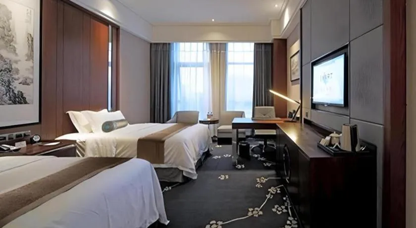 Bed in Jiyuan Oriental Jianguo Hotel