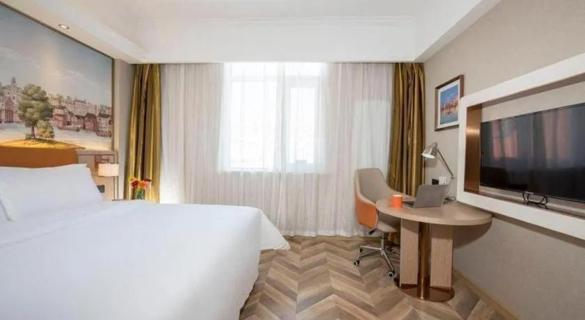 Bed in Vienna Hotel Tianjin Huaming