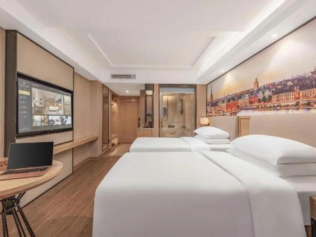 Bed in Vienna International Hotel Guangzhou Baiyun Dayuanli Plaza