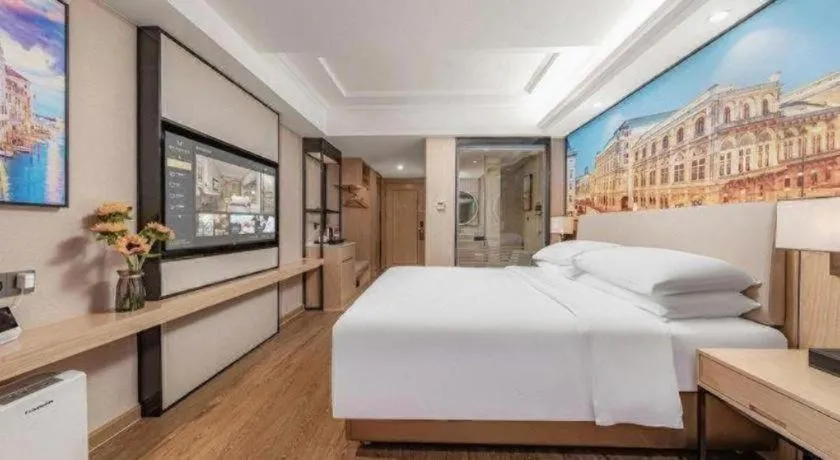 Bed in Vienna International Hotel Guangzhou Baiyun Dayuanli Plaza
