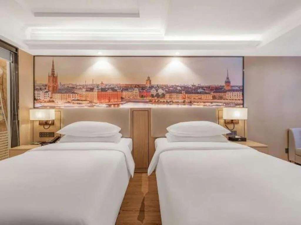 Bed in Vienna International Hotel Guangzhou Baiyun Dayuanli Plaza