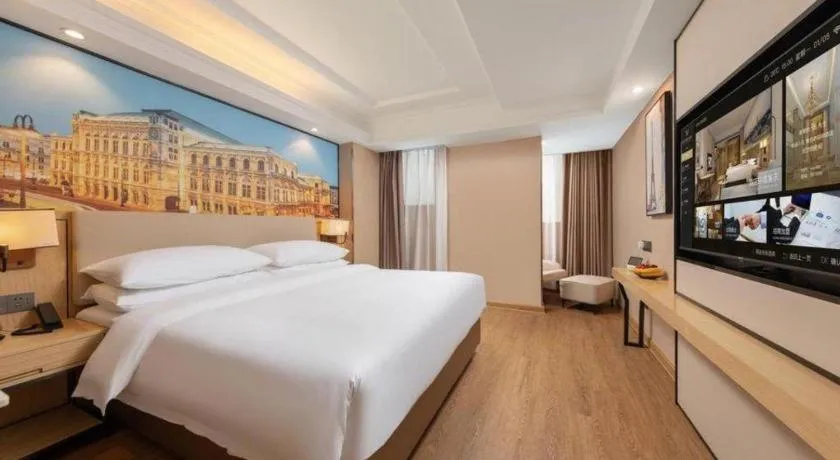 Bed in Vienna International Hotel Guangzhou Baiyun Dayuanli Plaza