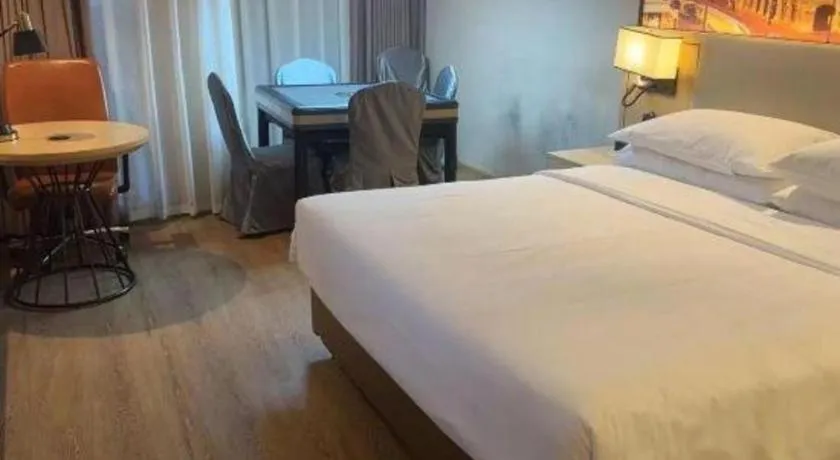 Bed in Vienna International Hotel Guangzhou Baiyun Dayuanli Plaza