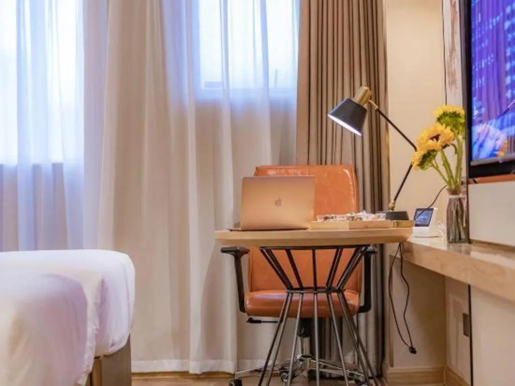 Bed in Vienna International Hotel Guangzhou Baiyun Dayuanli Plaza