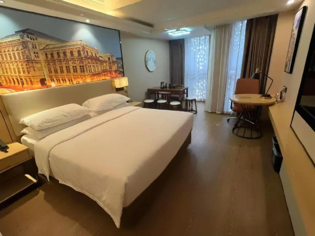 Bed in Vienna International Hotel Guangzhou Baiyun Dayuanli Plaza