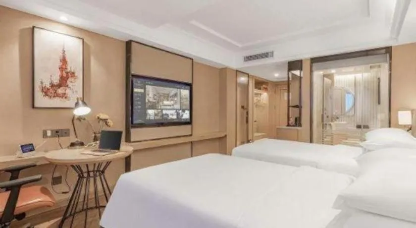 Bed in Vienna International Hotel Guangzhou Baiyun Dayuanli Plaza