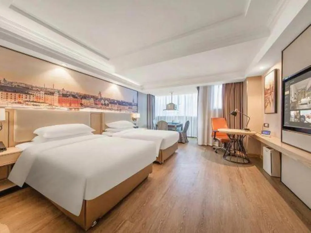 Bed in Vienna International Hotel Guangzhou Baiyun Dayuanli Plaza