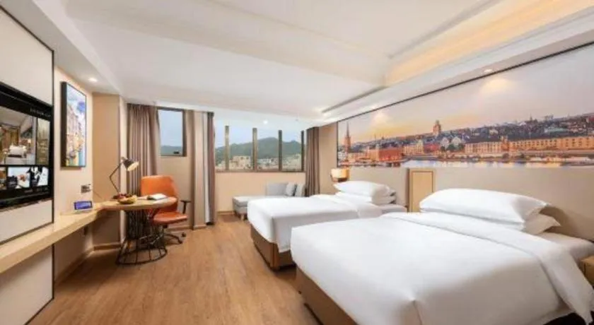 Bed in Vienna International Hotel Guangzhou Baiyun Dayuanli Plaza