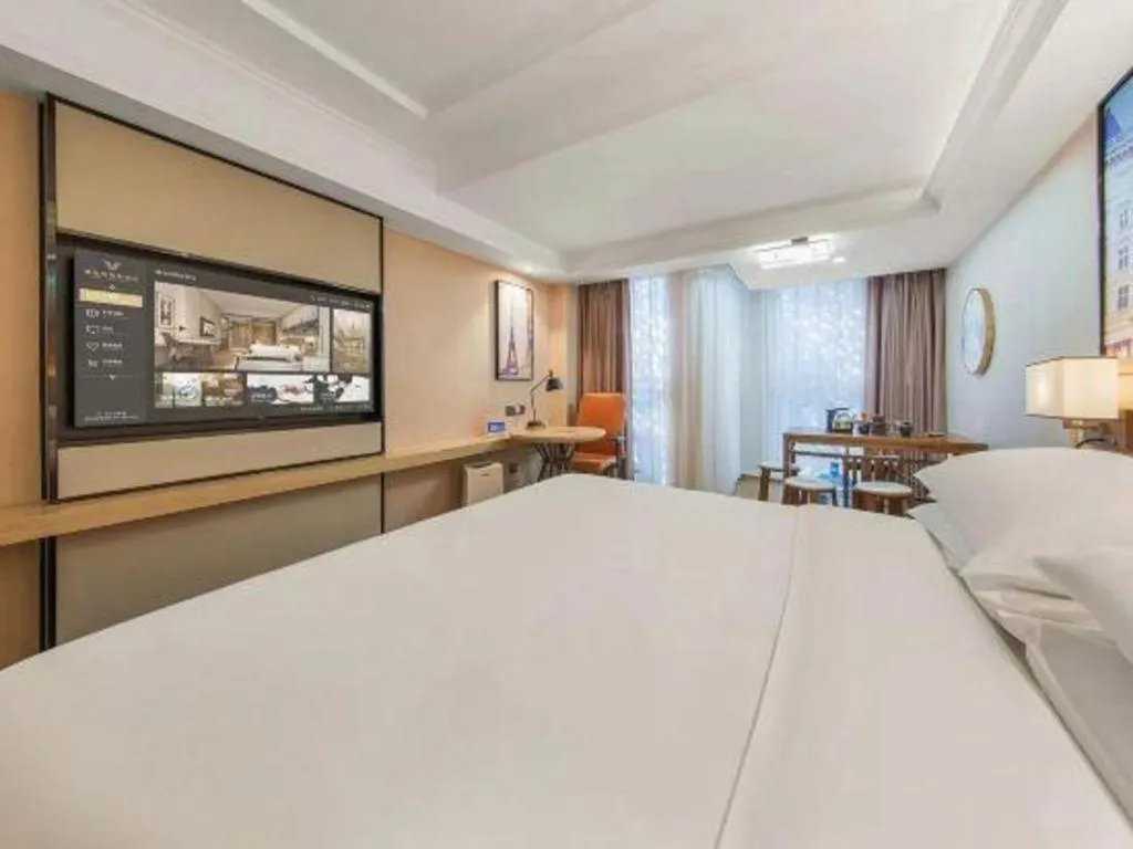 Bed in Vienna International Hotel Guangzhou Baiyun Dayuanli Plaza