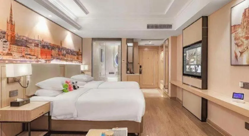 Bed in Vienna International Hotel Guangzhou Baiyun Dayuanli Plaza