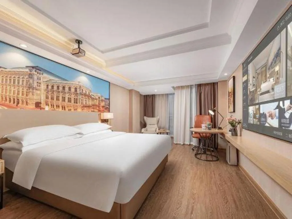 Bed in Vienna International Hotel Guangzhou Baiyun Dayuanli Plaza
