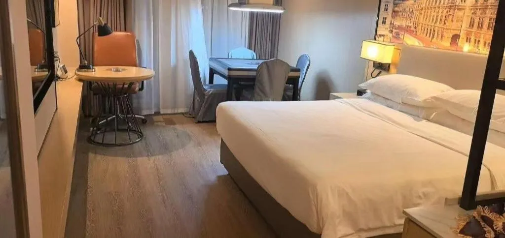 Bed in Vienna International Hotel Guangzhou Baiyun Dayuanli Plaza
