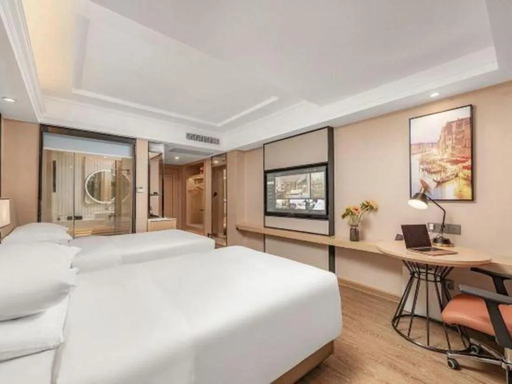 Bed in Vienna International Hotel Guangzhou Baiyun Dayuanli Plaza