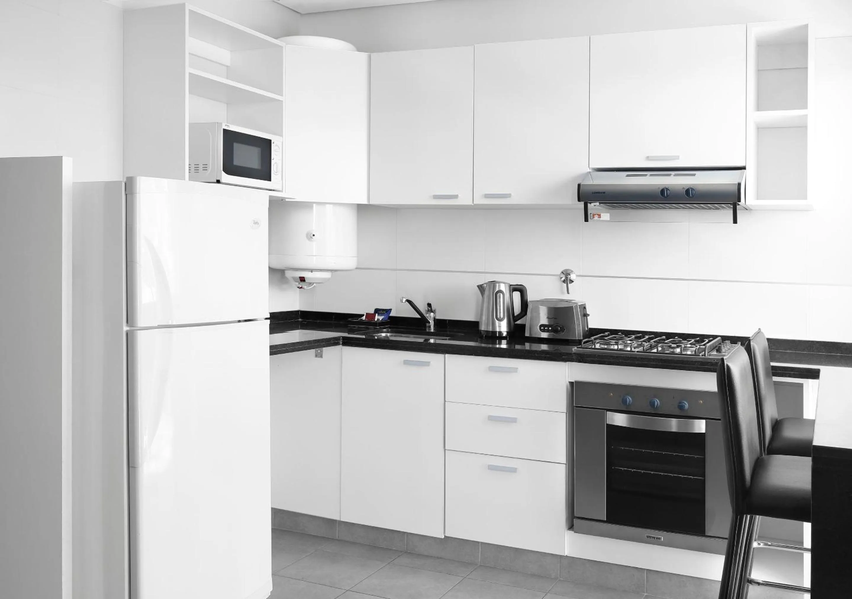 Kitchen or kitchenette in Reco by DOT Suites