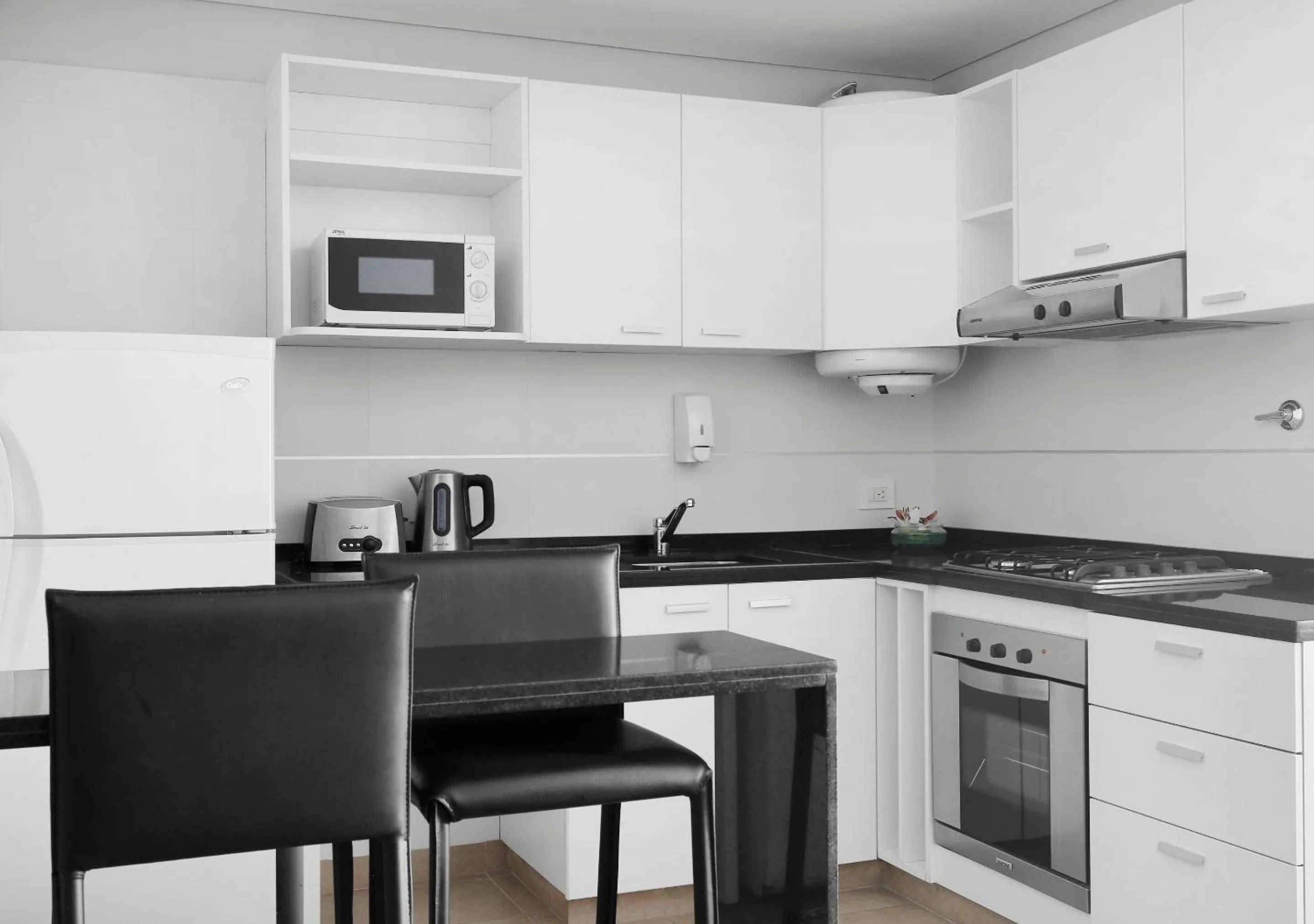 Kitchen or kitchenette in Reco by DOT Suites