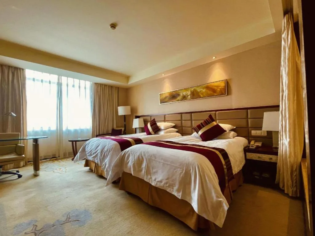 Bed in New Century Grand Hotel Lishui Huaqiao