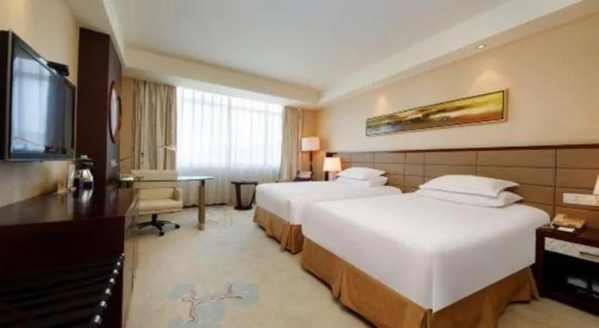 Bed in New Century Grand Hotel Lishui Huaqiao