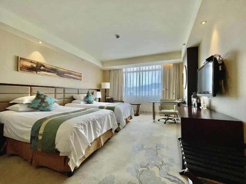 Bed in New Century Grand Hotel Lishui Huaqiao