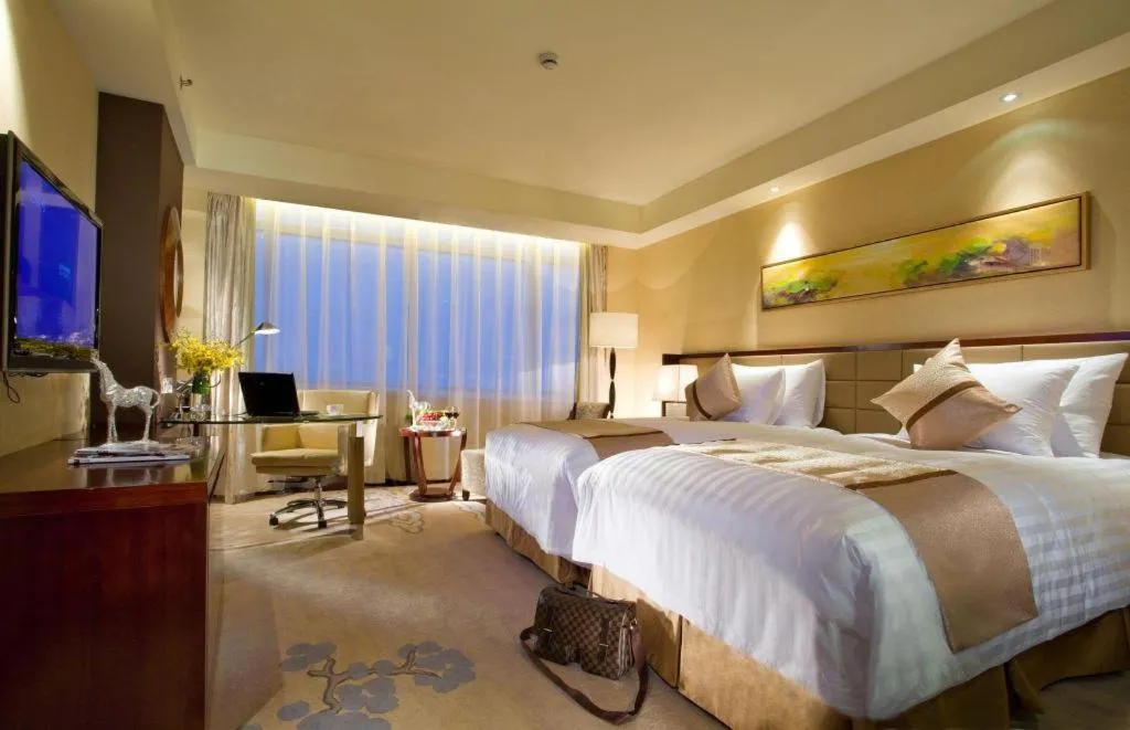 Bed in New Century Grand Hotel Lishui Huaqiao