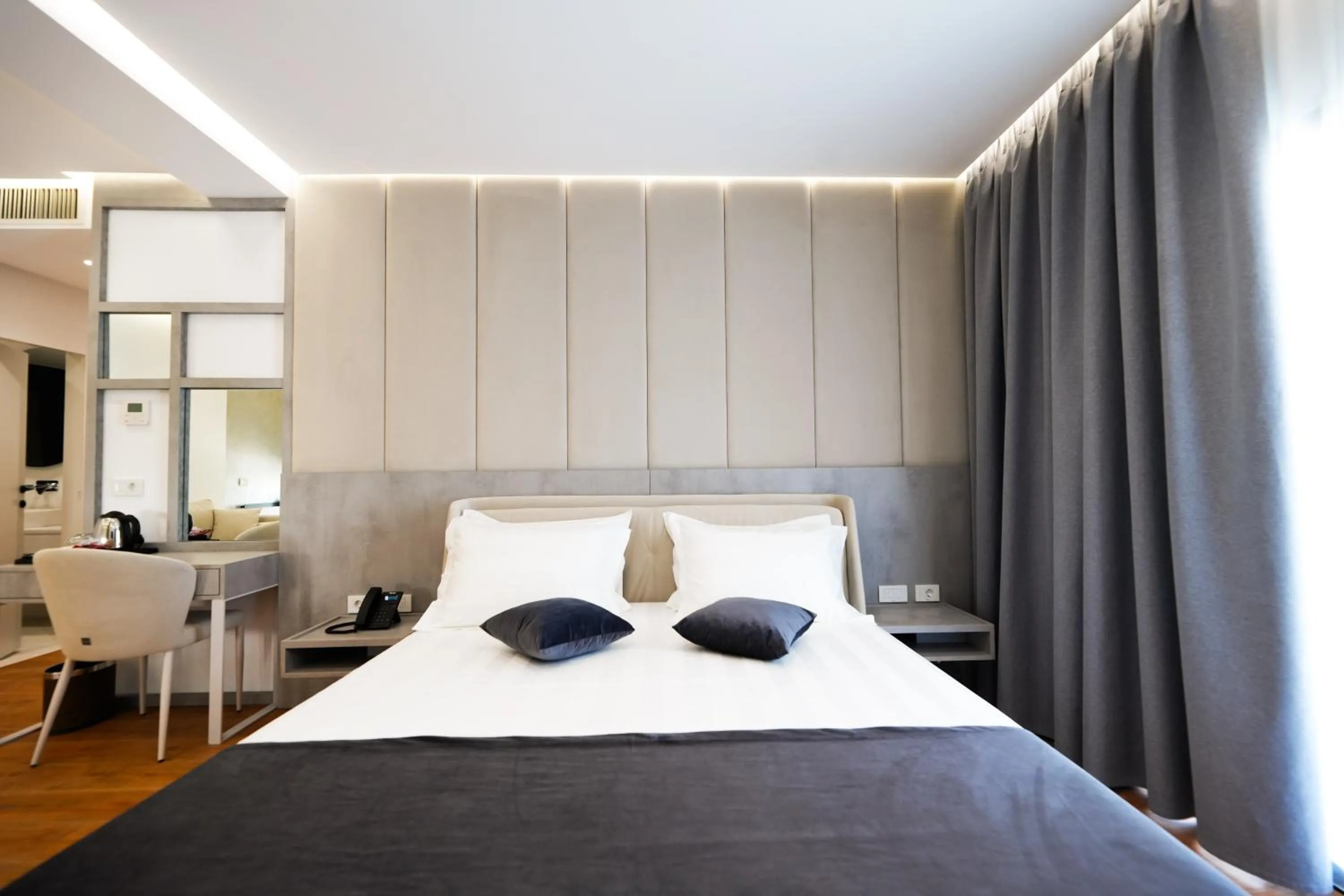 Bed in Naos Luxury Hotel