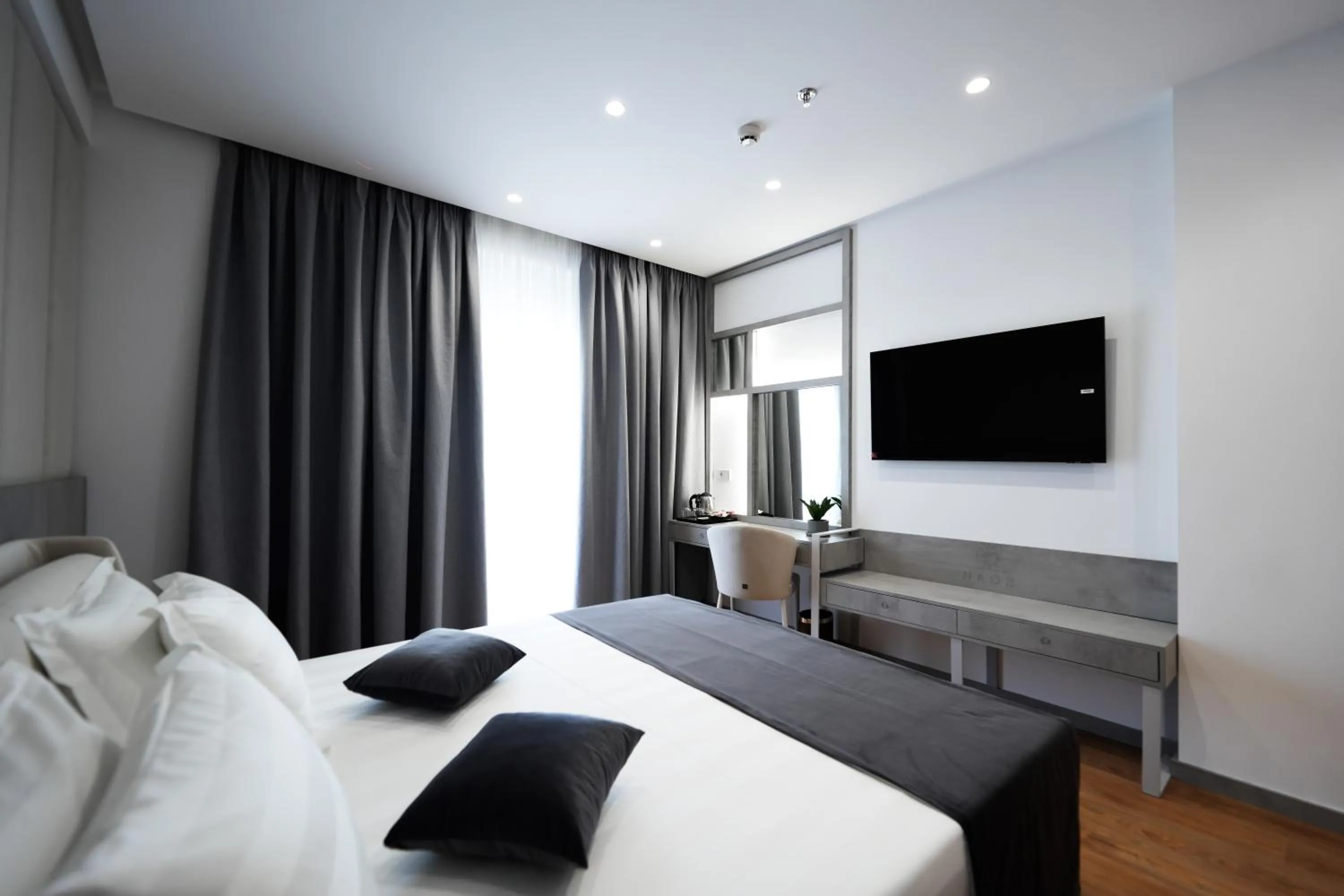 Bed in Naos Luxury Hotel