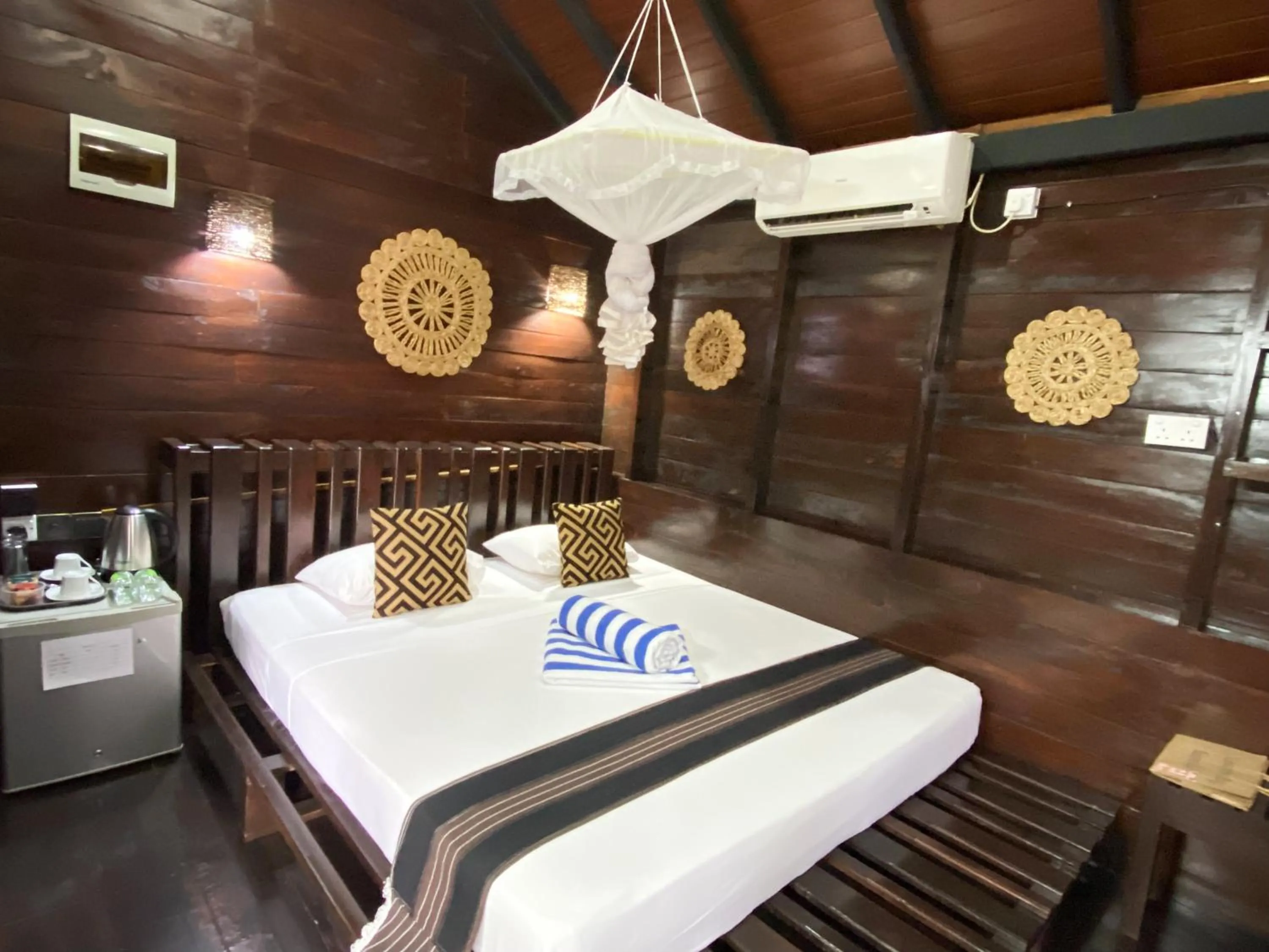 Bed in Coco Palm Villa and Cabanas