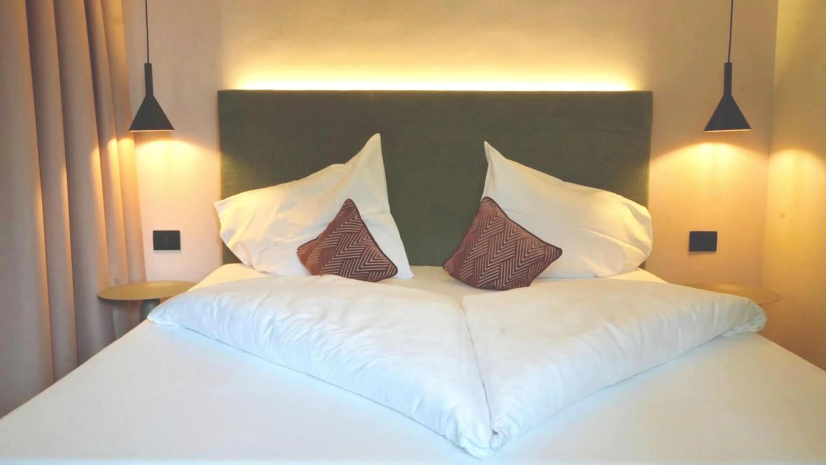 Bed in Flora Hotel & Suites