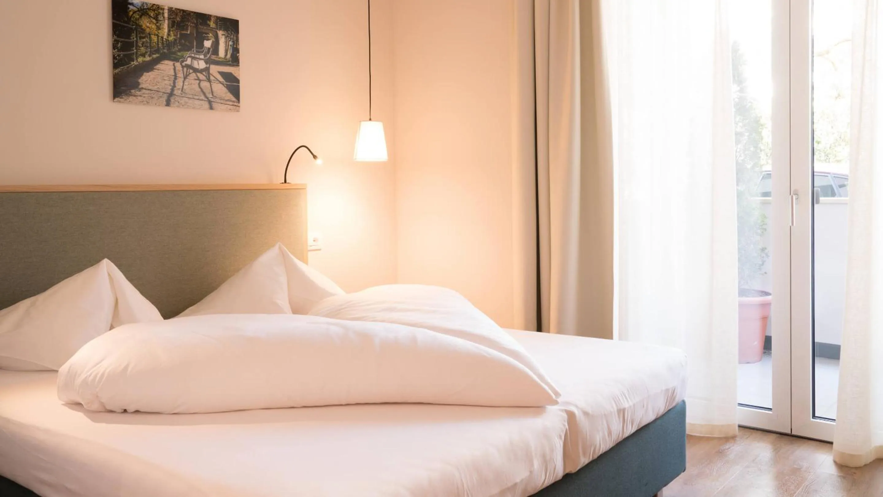 Bed in Flora Hotel & Suites