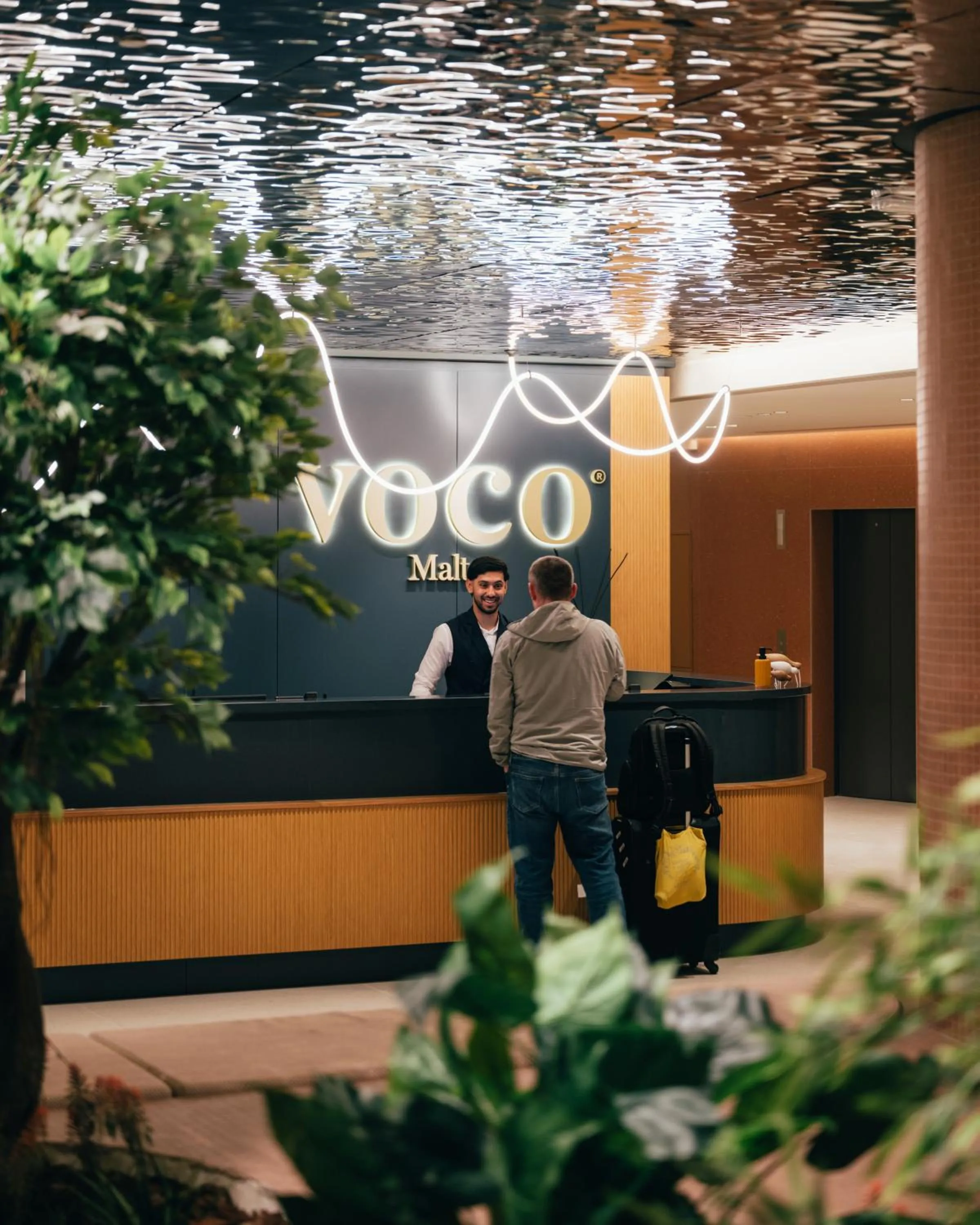 Lobby or reception in voco Malta by IHG