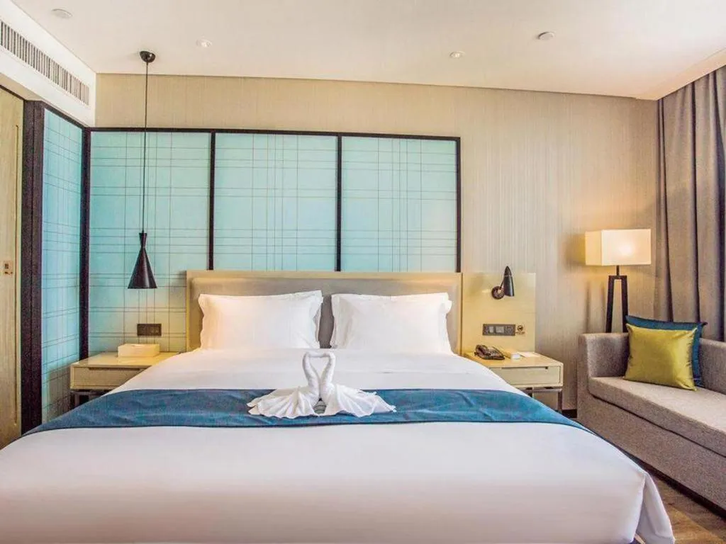 Bed in Echarm Hotel Qionghai Wanquan River