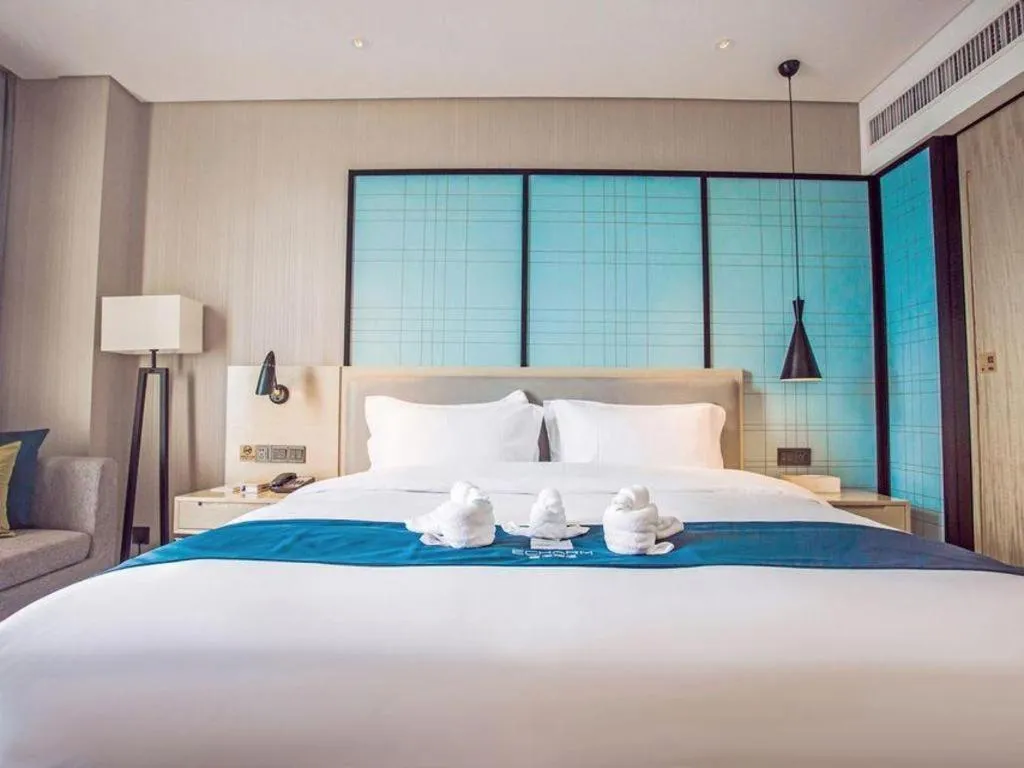 Bed in Echarm Hotel Qionghai Wanquan River