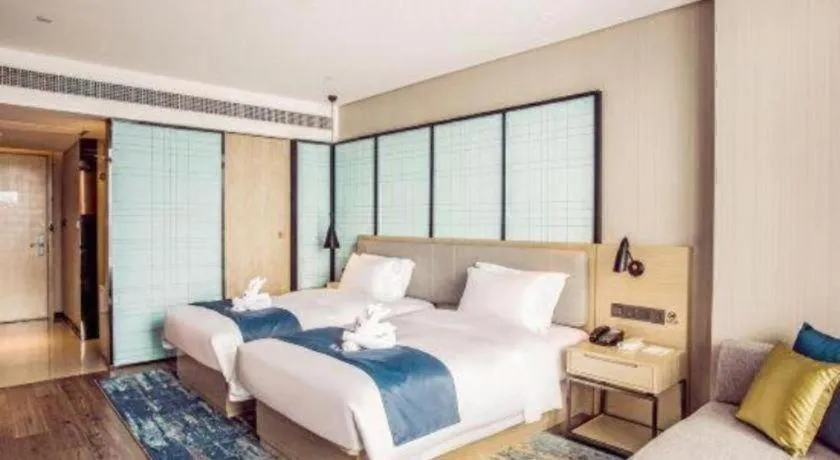 Bed in Echarm Hotel Qionghai Wanquan River
