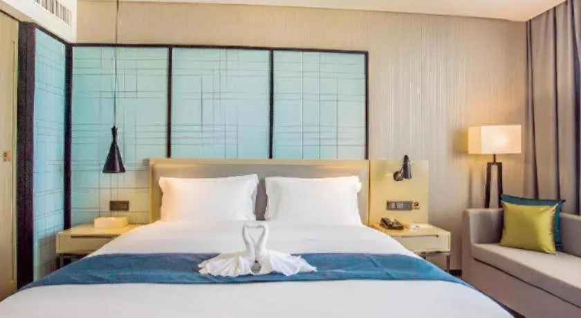 Bed in Echarm Hotel Qionghai Wanquan River