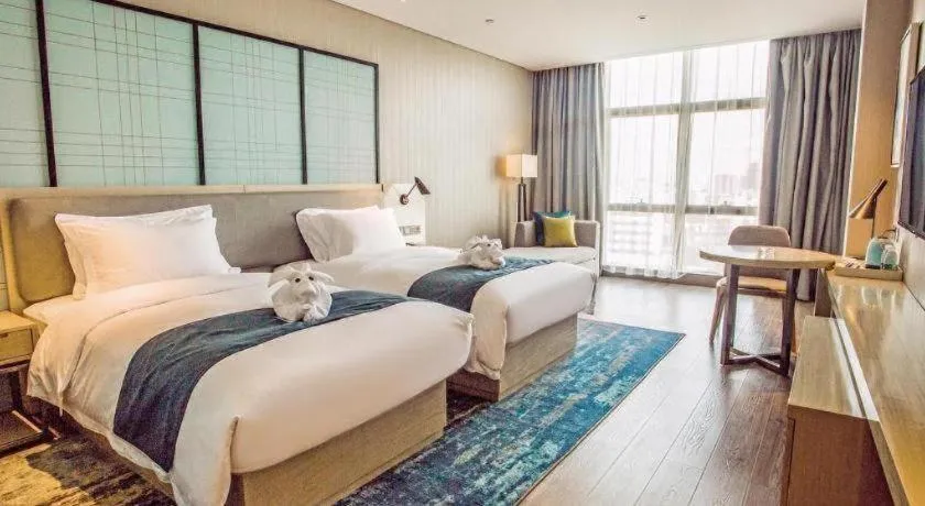 Bed in Echarm Hotel Qionghai Wanquan River