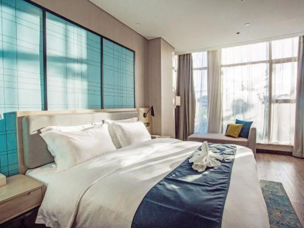 Bed in Echarm Hotel Qionghai Wanquan River