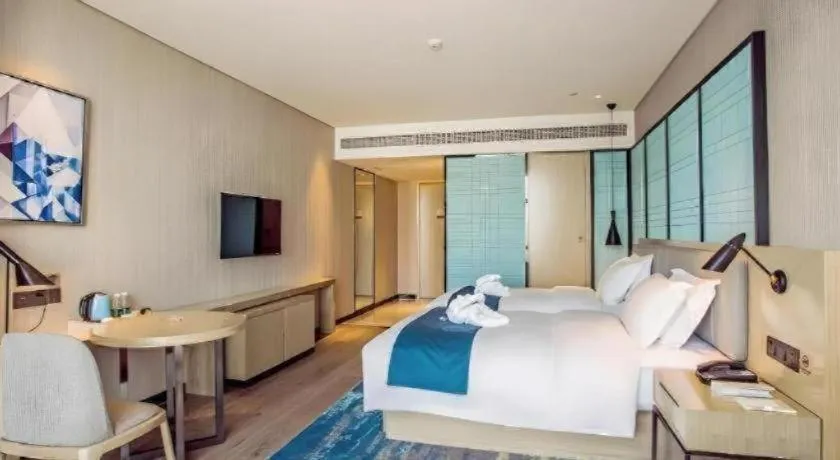 Bed in Echarm Hotel Qionghai Wanquan River