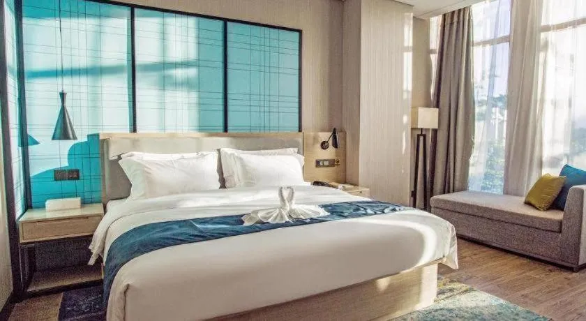 Bed in Echarm Hotel Qionghai Wanquan River