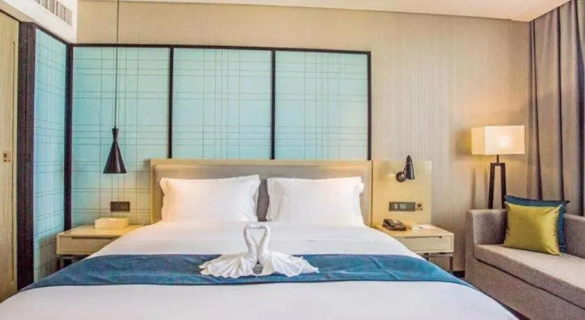 Bed in Echarm Hotel Qionghai Wanquan River