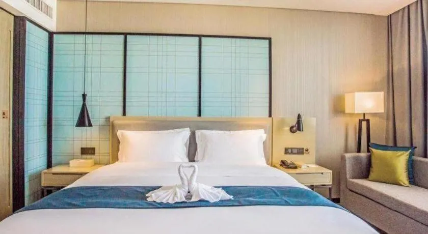 Bed in Echarm Hotel Qionghai Wanquan River