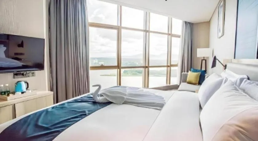 Bed in Echarm Hotel Qionghai Wanquan River