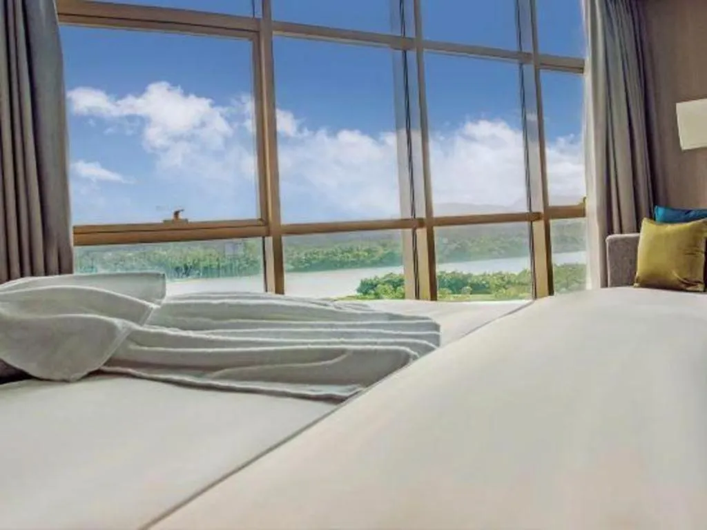 Bed in Echarm Hotel Qionghai Wanquan River